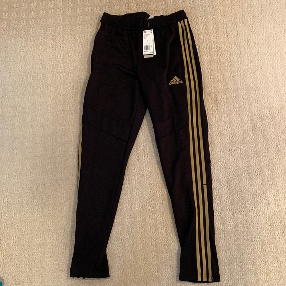Mens Adidas tapered fit track pants. Black with gold stripes